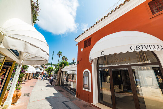Tourists by luxury stores in famous Via Camerelle