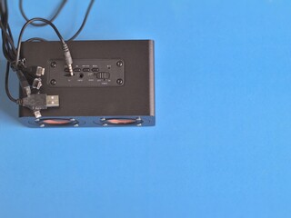 Blue background, channel switch, socket, power cable, USB micro USB cable, audio and radio waves,copy space