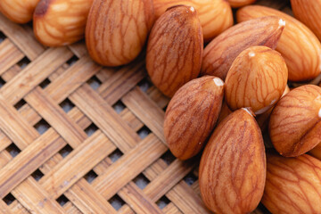 Almond nuts that have been unwrapped from the shell placed on a farmer's wooden grate, Health food with good fats and down aging, Antioxidants and lower cholesterol levels, Selective focus.