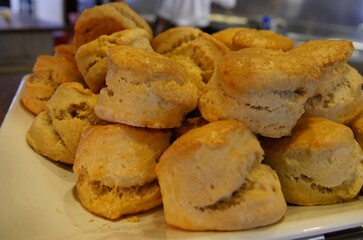 Freshly baked biscuits stacked on a platter