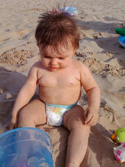 Cute little baby playing in the beach