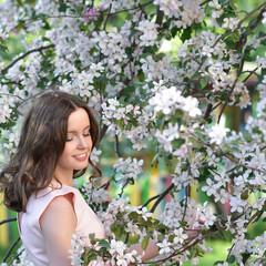 Fototapeta premium Girl in pink dress with apple tree flowes