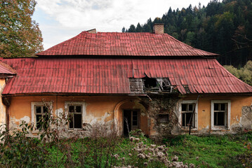 An old crumbling house with a red tiled roof, Mniszek, Poland