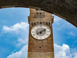 An old clock tower on the background of the blue sky, Verona, Italy