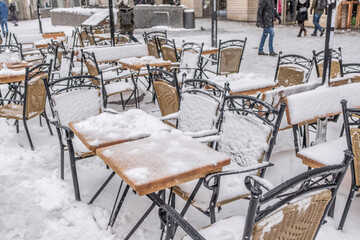 Stühle einer Gartenwirtschaft im Schnee
