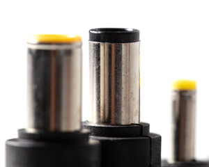 Plugs for charging a laptop on a white background