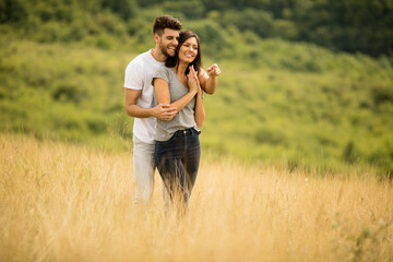 Fototapeta premium Pretty young couple in love outside in spring nature