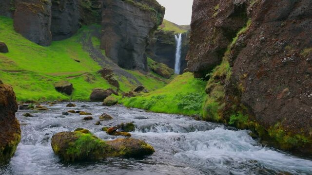 Spectacular midnight sun view of Kvernufoss watterfall. Gloomy summer scene of pure water river in Iceland, Europe. Beauty of nature concept background. Full HD video (High Definition)...