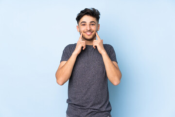 Arabian handsome man over isolated background smiling with a happy and pleasant expression