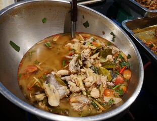 Dish of seafood favorite swimming in broth and seasoning displayed at the night food market in Chiang Mai, Thailand