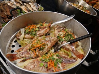 Close up of a pot of steamed flavored fish displayed in open stalls by the streetsides in Chiang Mai, Thailand