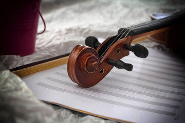Fototapeta na wymiar Closeup Scroll of violin put on background,vintage tone,blurry light around