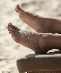 Close-up of a girl's leg on the beach.