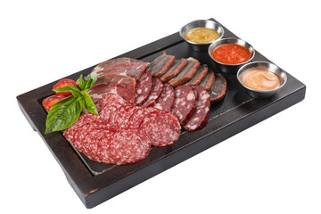 assorted smoked meats, salami sausages on a board on a white background
