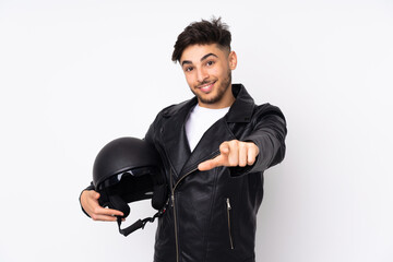 Arabian man with a motorcycle helmet isolated on white background points finger at you with a confident expression