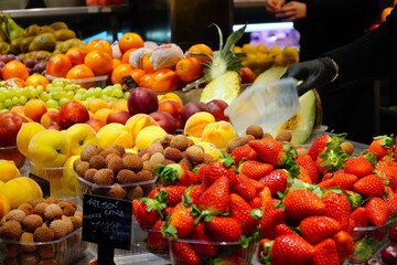 Famous La Boqueria market with fresh fruits in Barcelona, Spain.