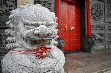 Stone gate guardian lion outside a Chinese temple
