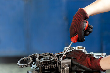 master repairing gear in garage on blue background