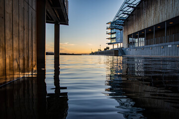 Sunset on the bay, wooden architectural design, reflection on the water surface