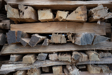 Firewood cut, split and stacked to be seasoned and ready for cooking or heating in winter. Neatly arranged split logs.