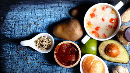 Fruit and vegetable dishes with rice porridge, congee on a wooden background