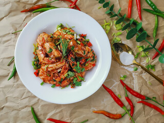 Stir Fried Prawns with Salt,garlic and Chili in white dish on Brown paper background