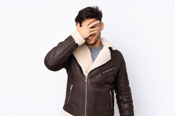 Arabian handsome man over isolated background covering eyes by hands and smiling
