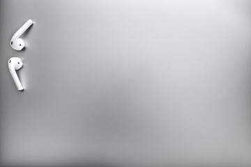 Top view of white headphones on a gray background. Space for copy.