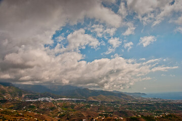Storm clouds surrounding Nerja and The Moorish village of Frigiliana nestling in the mountains, Costa del Sol, Andalucia, Spain