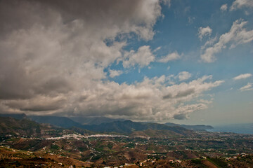 Storm clouds surrounding Nerja and The Moorish village of Frigiliana nestling in the mountains, Costa del Sol, Andalucia, Spain