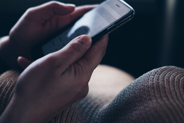 Closeup of hands holding the mobile phone for business and personal use. Selective focus. Copy...