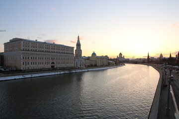 panorama cityscape shot of Moscow river, Saint Sophia Church, Christ the Saviour Cathedral and the walls of Kremlin monument. Taken in Moscow, Russia from a bridge during bright yellow sunset