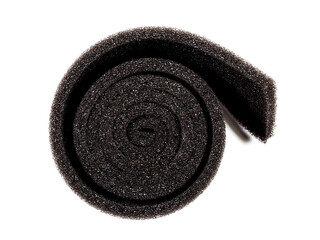 Black sponge sheet roll in a circle as a background. Top view
