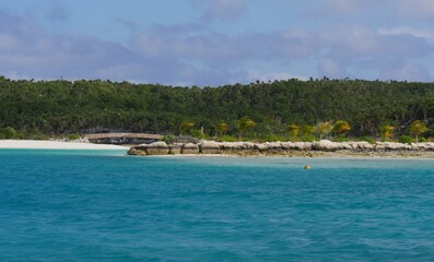 Idyllic tropical island covered with lush forests at the Exuma Cays, a popular tourist destination in the Bahamas.