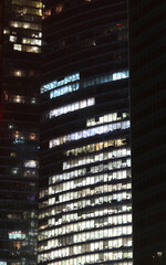 Close up of modern skyscraper illuminated at night