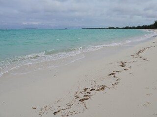 Deserted beach with soft powdery white sands with washed out seaweeds