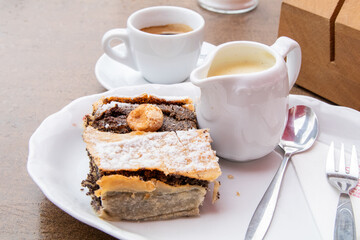 Cake and coffee with cream at cafe