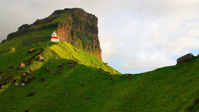 Evening view of Kallur Lighthouse, Kalsoy island. Gorgeous summer sunset on Faroe Islands, Kingdom of Denmark, Europe. Fantastic seascape of Atlantic ocean. Full HD video (High Definition).