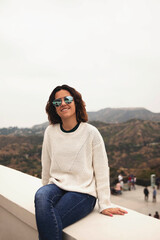 Portrait of happy and pretty girl at Griffith Observatory in her travel for Los Angeles, California.