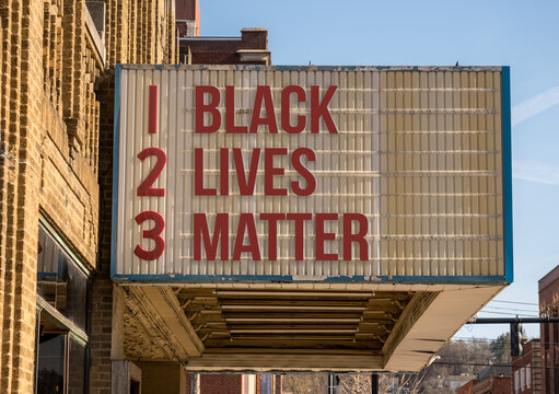 Mockup of movie cinema billboard with message of Black Lives Matter on the marquee sign in downtown street