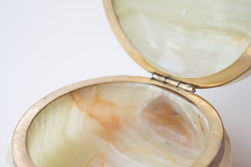 luxurious natural onyx jewelry box on white marble. top view, minimalism concept. vintage casket onyx.