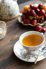 cup of hot tea and a plate of seasonal berries on the kitchen table
