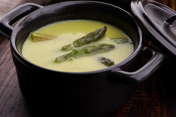 Green spring pureed asparagus soup served in plates