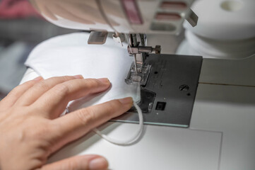 People sew the white face mask to protect themselves from the situation of Covid 19