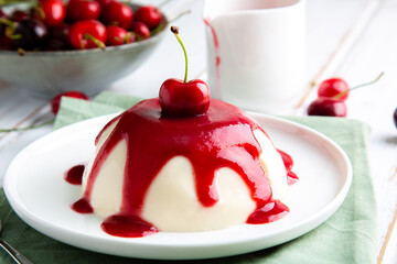Italian panna cotta dessert with cherry coulis