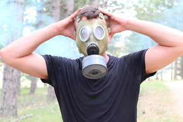 Man wearing rubber mask in toxic environment 