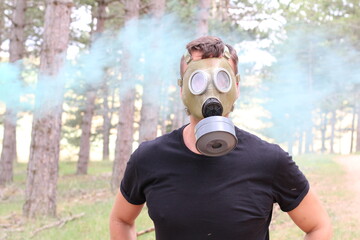 Survivor in contaminated forest wearing gas mask