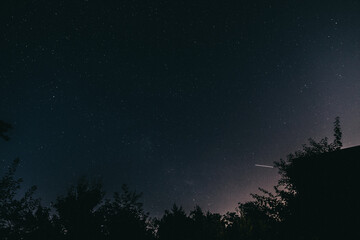 Night starry sky in the village in spring
