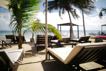 View of empty massage bed on the beach near palm tree and Caribbean sea in Mexico,Costa Maya.