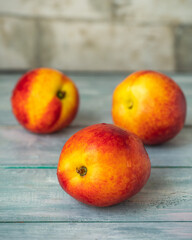 Ripe nectarines on a wooden blue tray